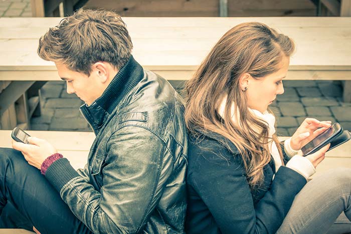 couple sitting & texting